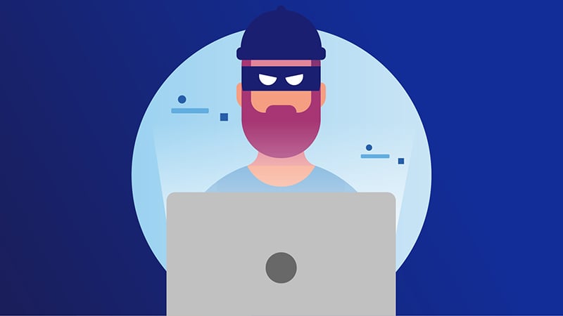 A thief sitting in front of a laptop, symbolising the increased security provided by 3DS authentication