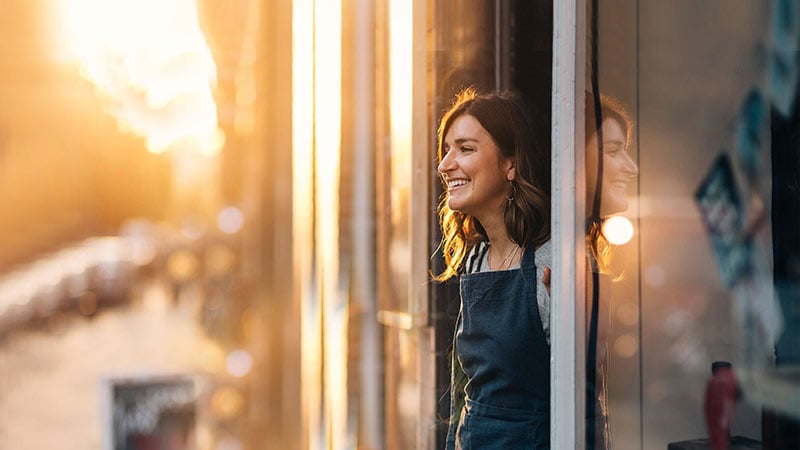 Smiling female owner looking away