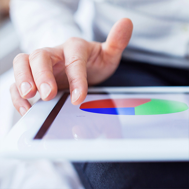 hand resting on tablet with image of a chart